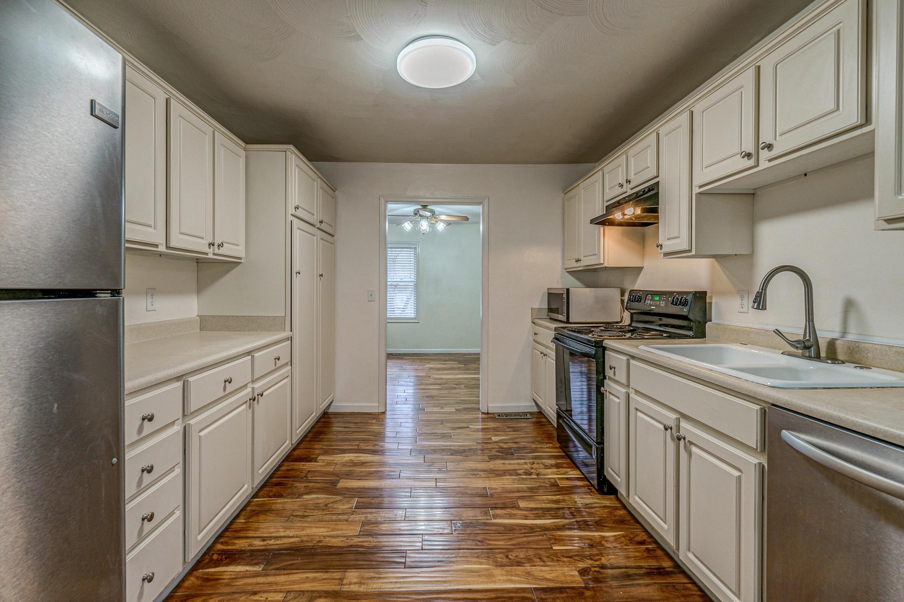6071 Goodview Road Goodview, VA 24095 - Photo 14 of 44 a kitchen with white cabinets appliances and a sink