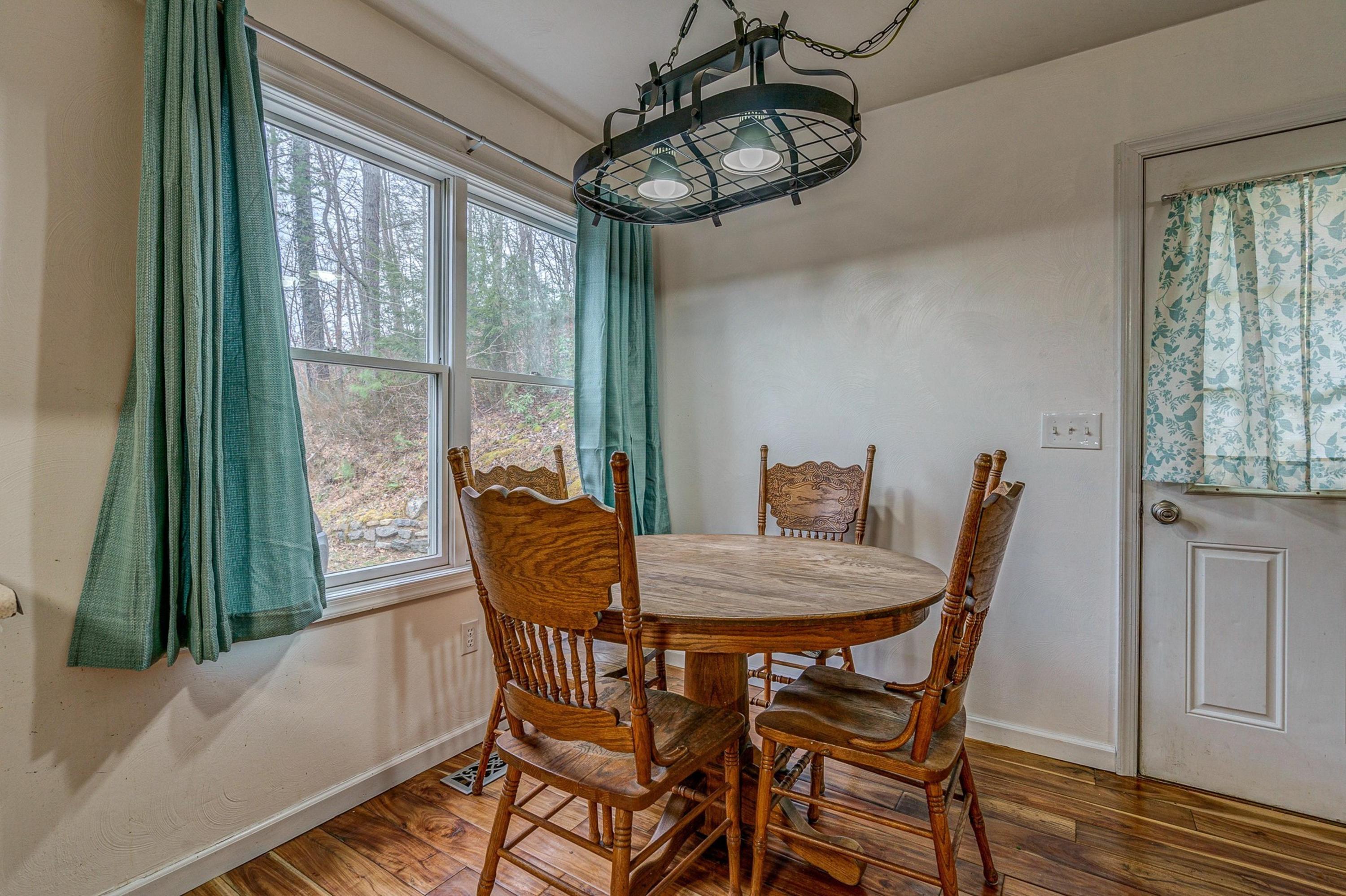 6071 Goodview Road Goodview, VA 24095 - Photo 16 of 44 a view of a dining room with furniture window and wooden floor