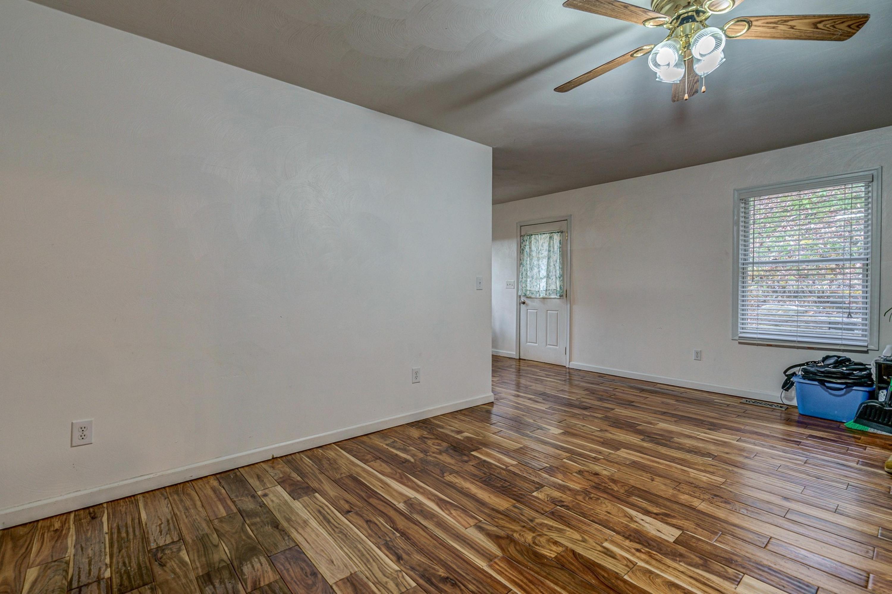 6071 Goodview Road Goodview, VA 24095 - Photo 17 of 44 wooden floor in an empty room with a window