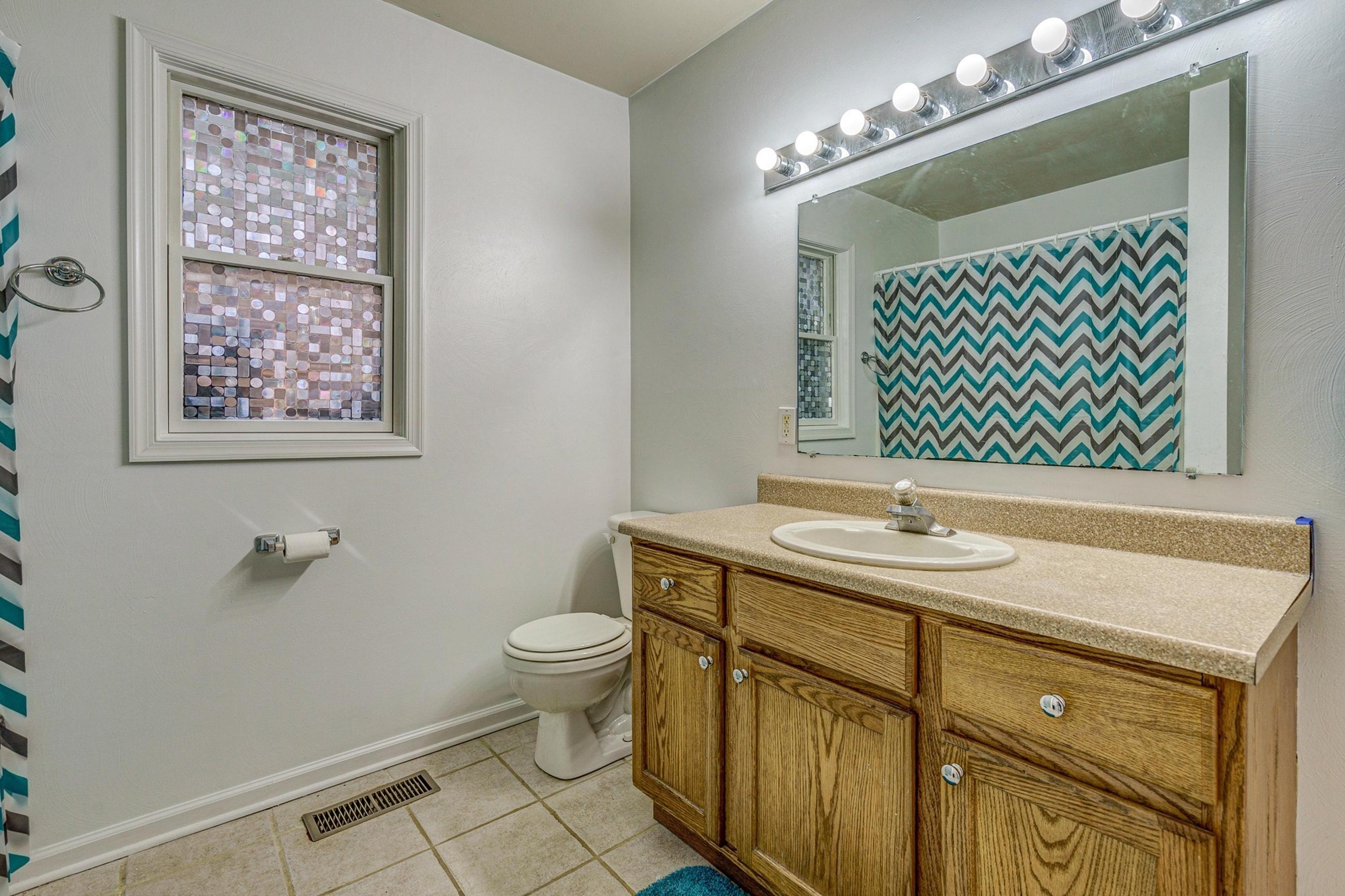 6071 Goodview Road Goodview, VA 24095 - Photo 18 of 44 a bathroom with a sink a toilet and mirror