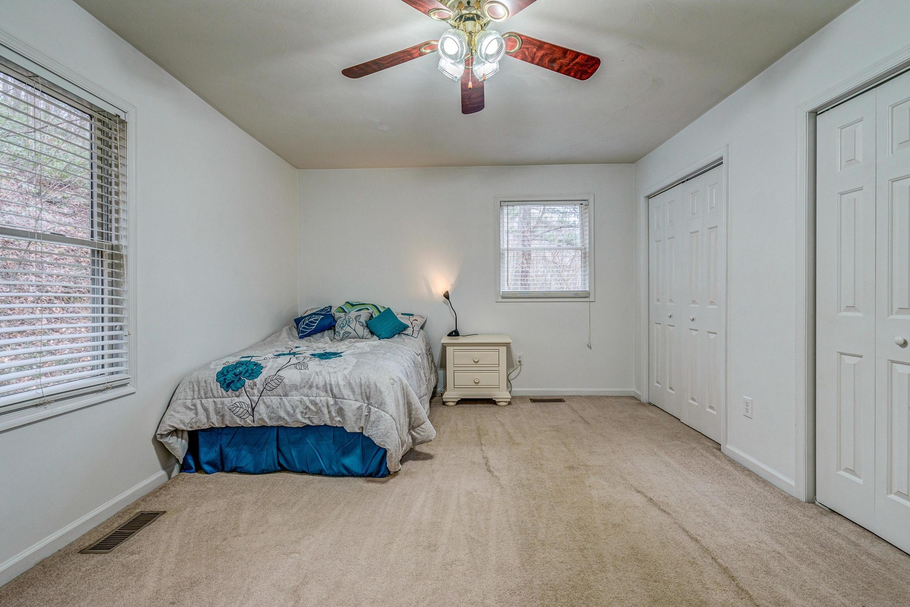 6071 Goodview Road Goodview, VA 24095 - Photo 21 of 44 a bedroom with a bed and a chandelier