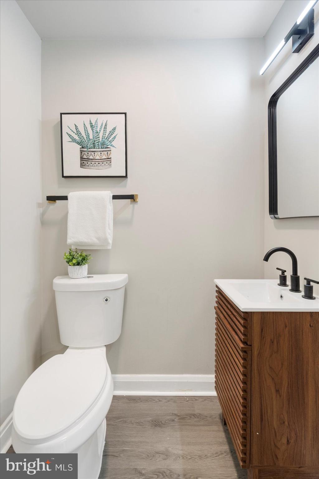 1020 Wicklow Road Baltimore, MD 21229 - Photo 18 of 44 a bathroom with a toilet a sink and mirror