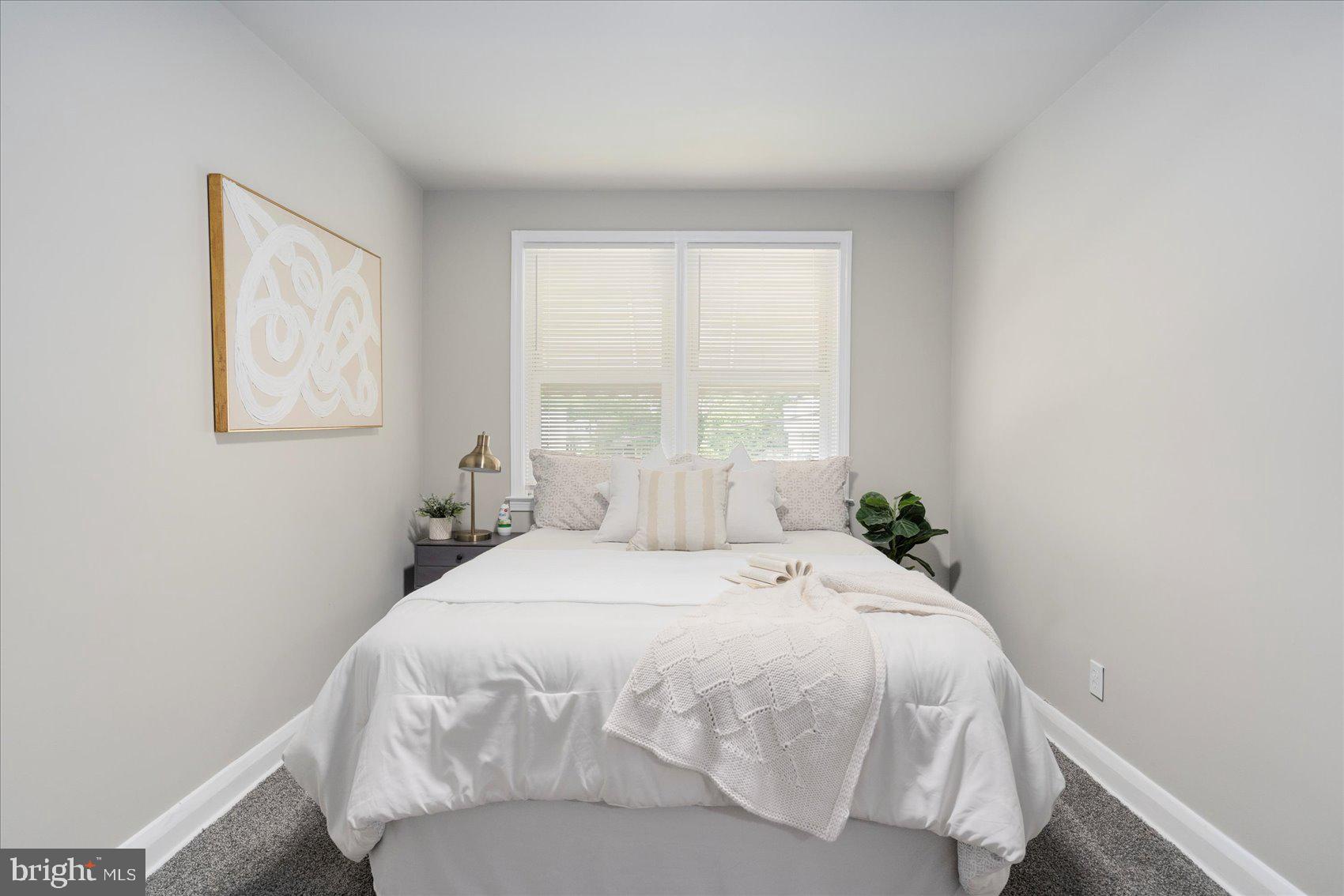 1020 Wicklow Road Baltimore, MD 21229 - Photo 21 of 44 a large bed sitting in a bedroom next to a window