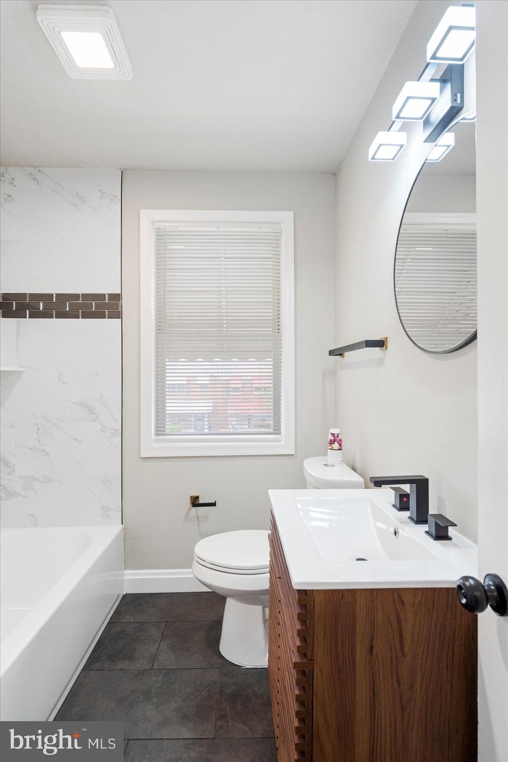 1020 Wicklow Road Baltimore, MD 21229 - Photo 29 of 44 a bathroom with a sink a toilet and a bathtub