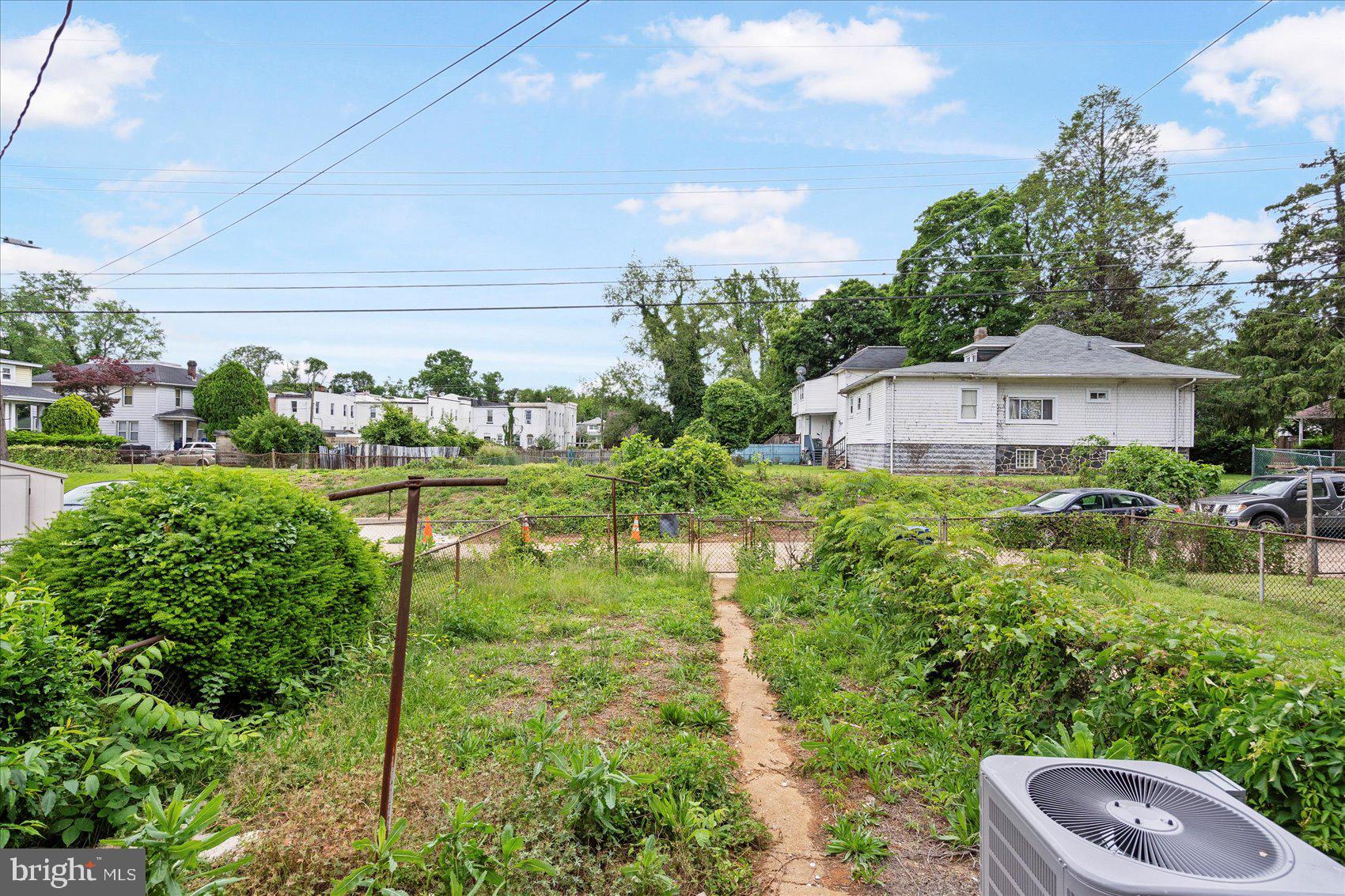 1020 Wicklow Road Baltimore, MD 21229 - Photo 43 of 44 a backyard of a house with lots of green space and plants