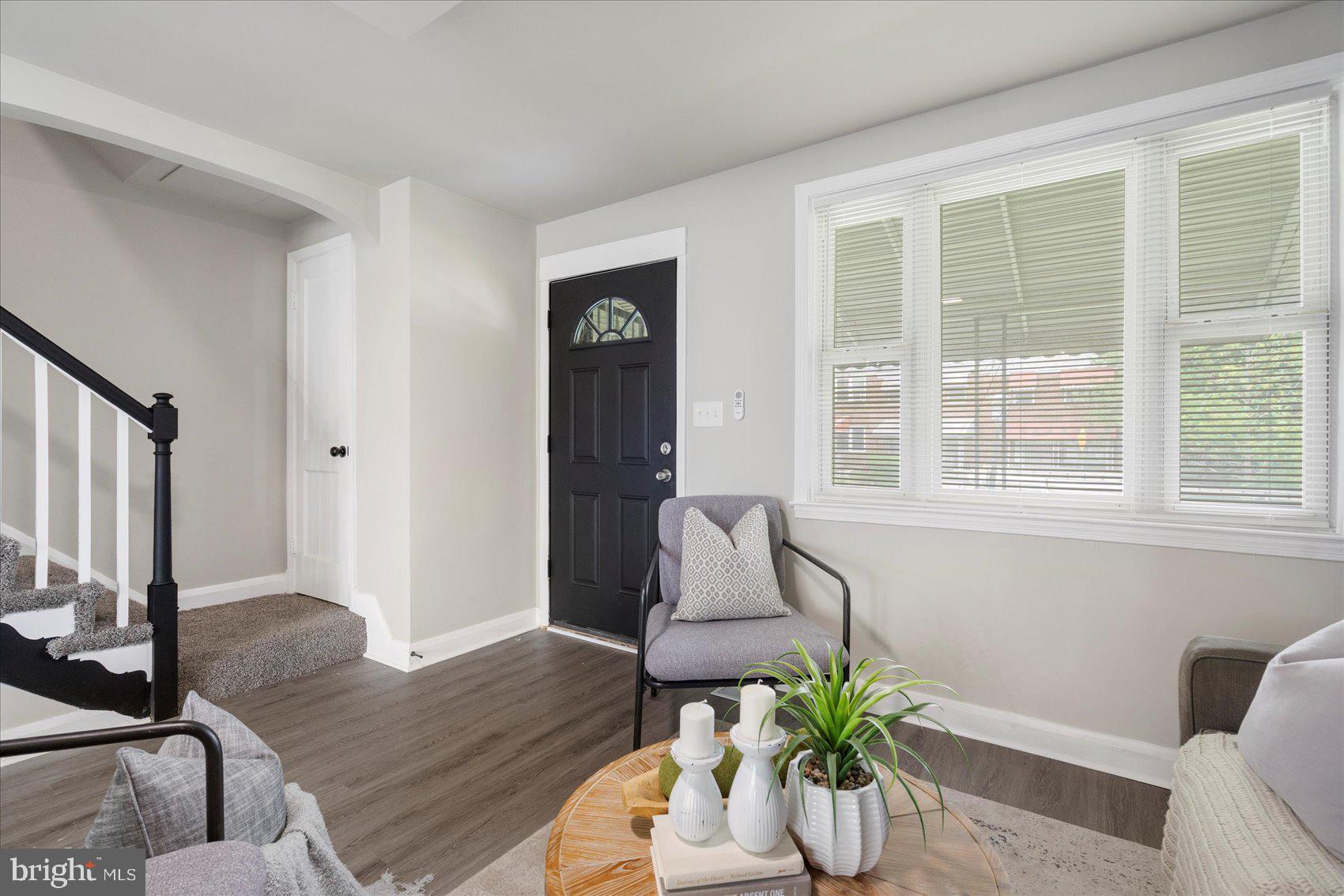 1020 Wicklow Road Baltimore, MD 21229 - Photo 7 of 44 a vase of flowers sitting on a table with a potted plant