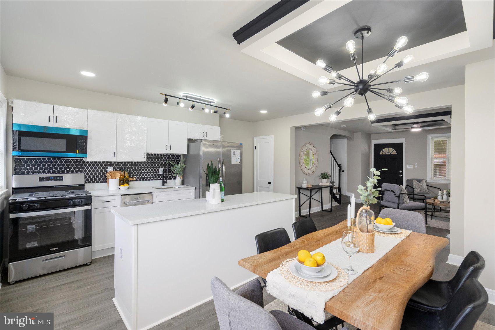 1020 Wicklow Road Baltimore, MD 21229 - Photo 10 of 44 a kitchen with a dining table chairs stainless steel appliances and cabinets