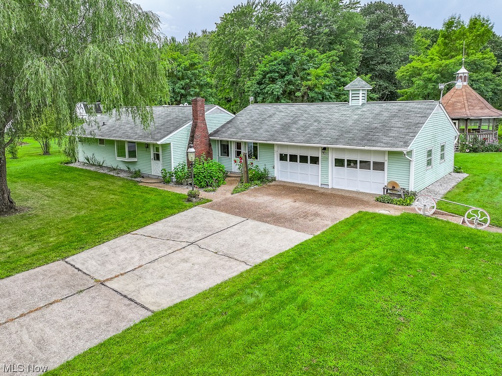 206 Bates Road Madison, OH 44057 - Photo 2 of 28 Ranch-style home featuring garage and a front yard