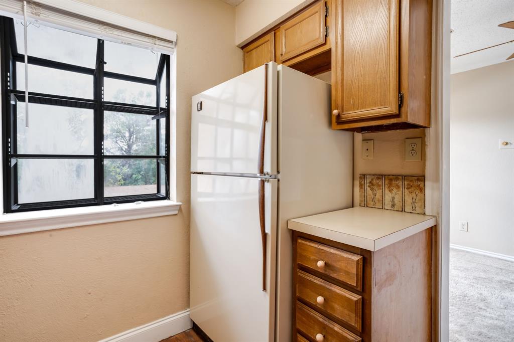 16301 Ledgemont Lane, Unit 267 Addison, TX 75001 - Photo 12 of 25 a kitchen with stainless steel appliances granite countertop a refrigerator and a window