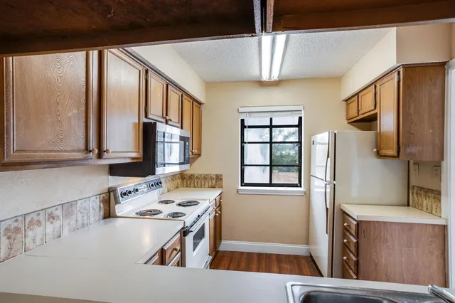 a kitchen with stainless steel appliances a stove a sink and a refrigerator