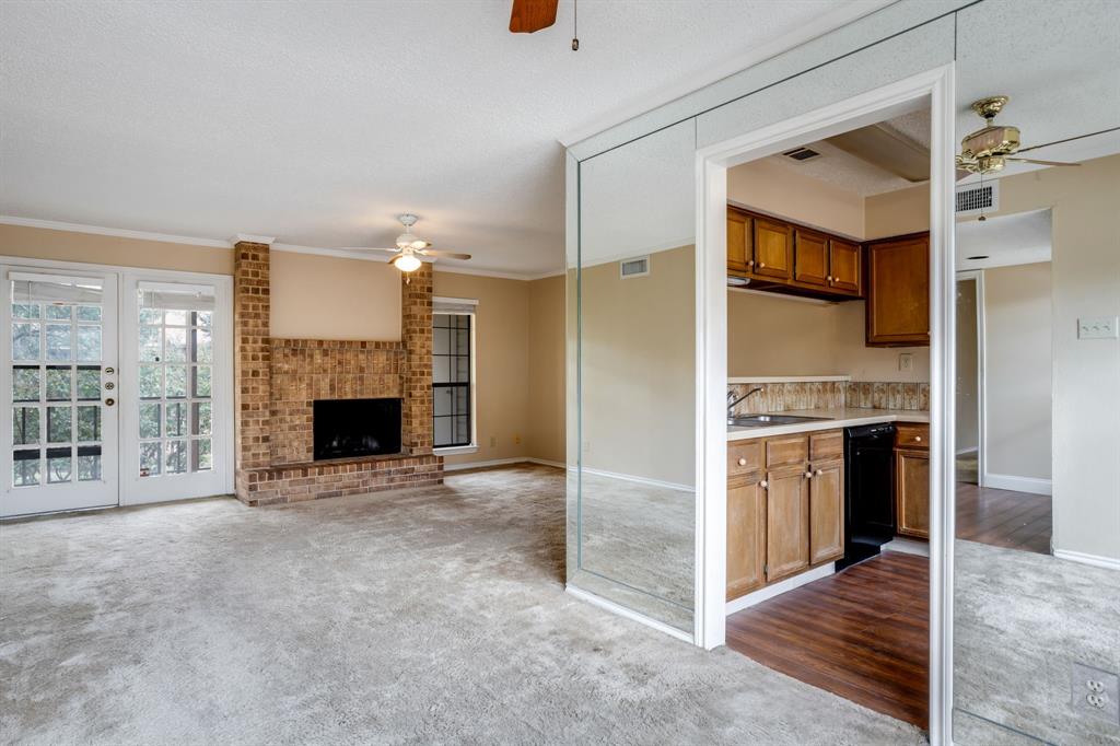 16301 Ledgemont Lane, Unit 267 Addison, TX 75001 - Photo 14 of 25 a view of a kitchen with furniture and a fireplace