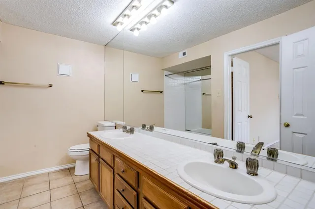 a bathroom with a sink double vanity and a toilet