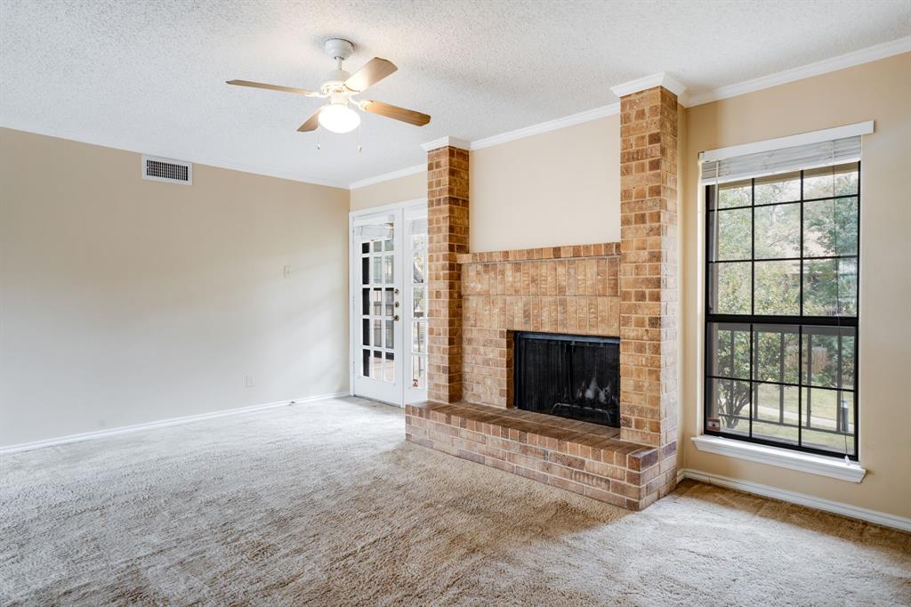 16301 Ledgemont Lane, Unit 267 Addison, TX 75001 - Photo 7 of 25 a view of a livingroom with a fireplace and a ceiling fan