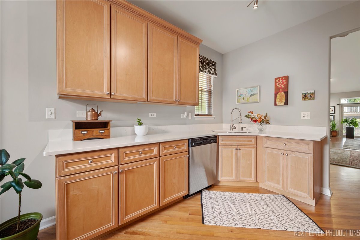 332 Wolcott Lane Batavia, IL 60510 - Photo 12 of 28 a kitchen with stainless steel appliances granite countertop a sink a stove cabinets and wooden floor