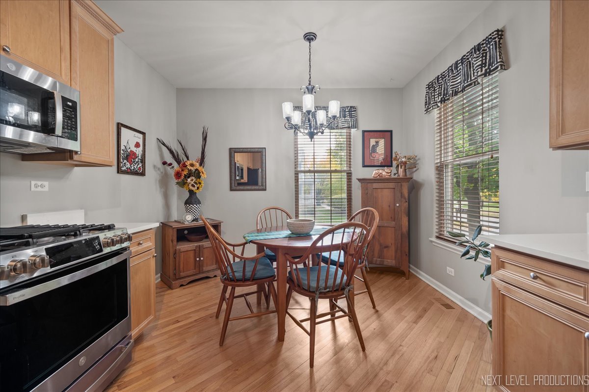 332 Wolcott Lane Batavia, IL 60510 - Photo 13 of 28 a dining room with furniture a chandelier and wooden floor