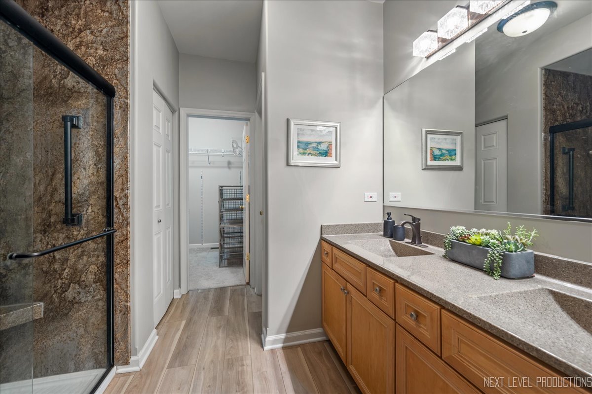 332 Wolcott Lane Batavia, IL 60510 - Photo 16 of 28 a bathroom with a sink a mirror and a shower