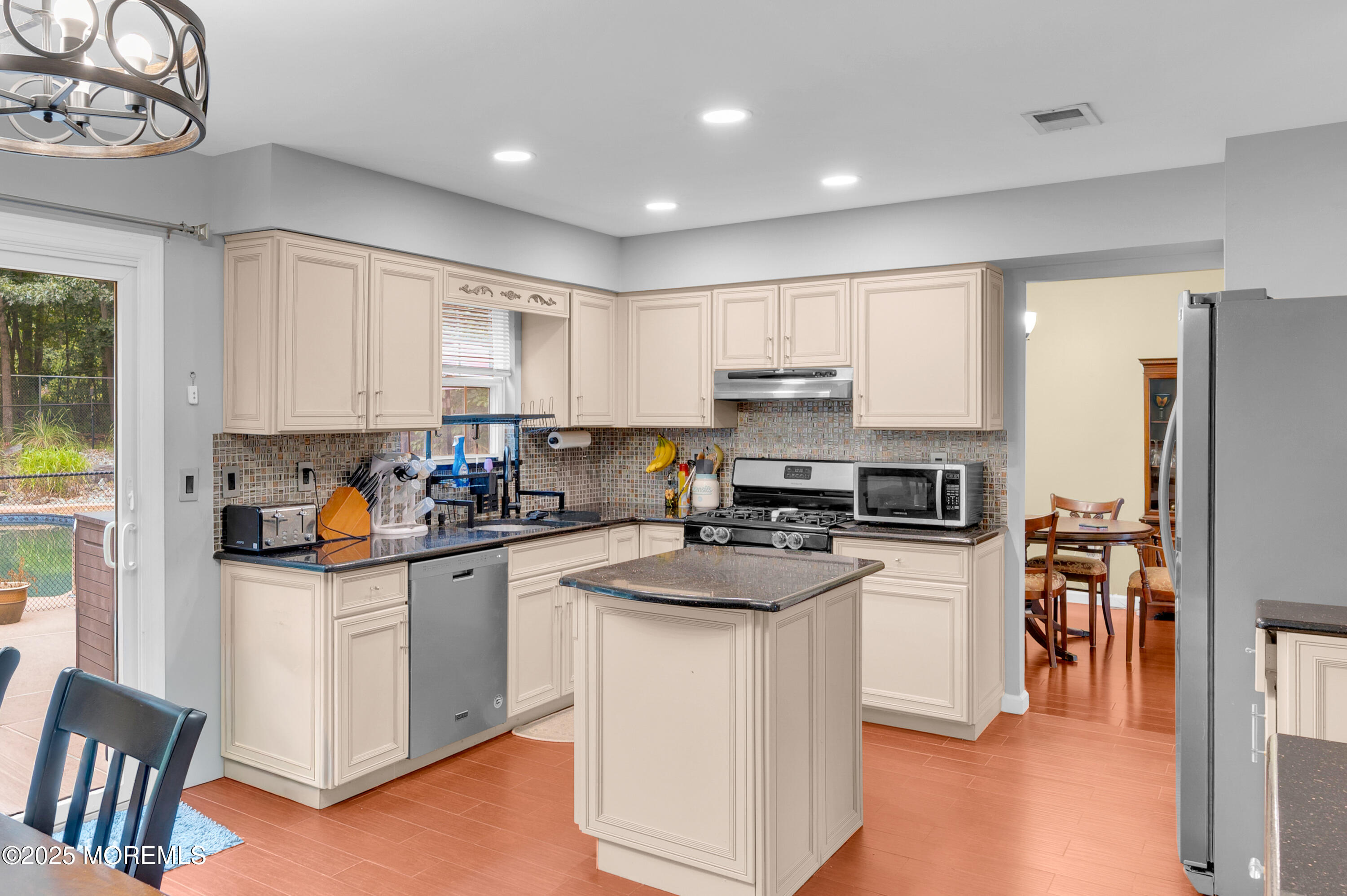 76 Diamond Lane Howell, NJ 07731 - Photo 12 of 36 a kitchen with stainless steel appliances granite countertop a stove top oven a refrigerator a sink and dishwasher with white cabinets