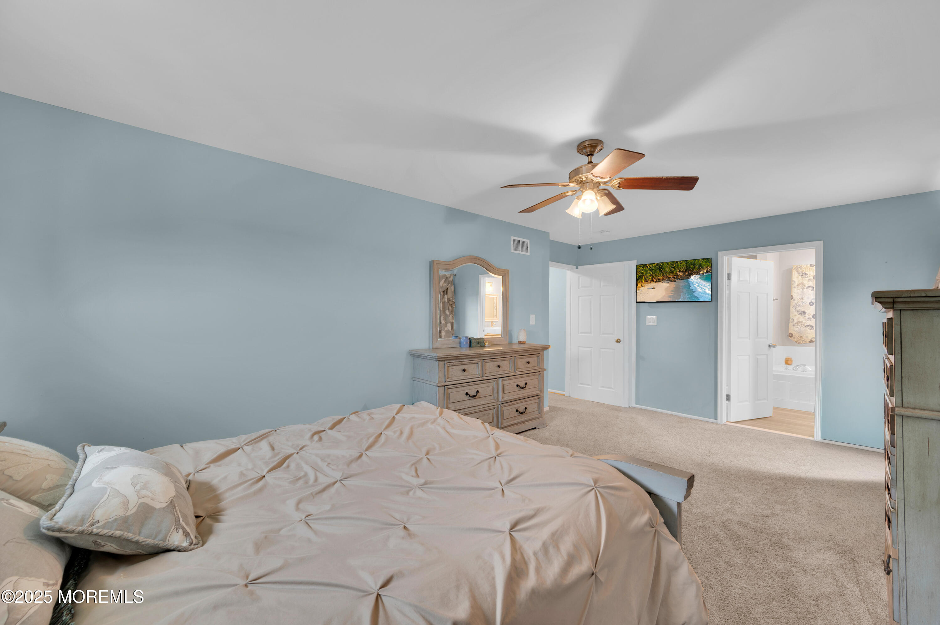 76 Diamond Lane Howell, NJ 07731 - Photo 19 of 36 a bedroom with a large bed and a chandelier