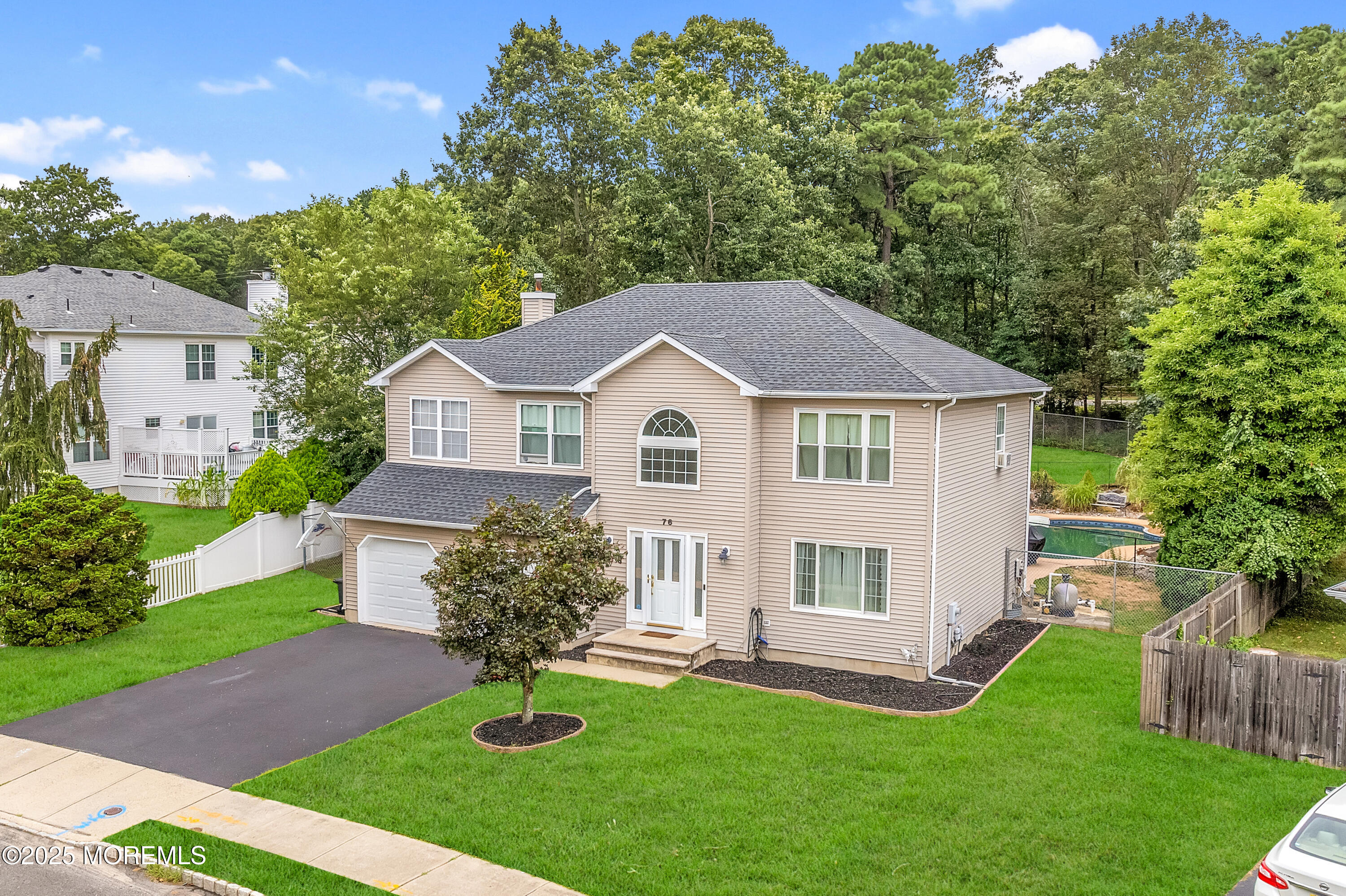 76 Diamond Lane Howell, NJ 07731 - Photo 2 of 36 a view of a yard in front of a house with plants and large tree