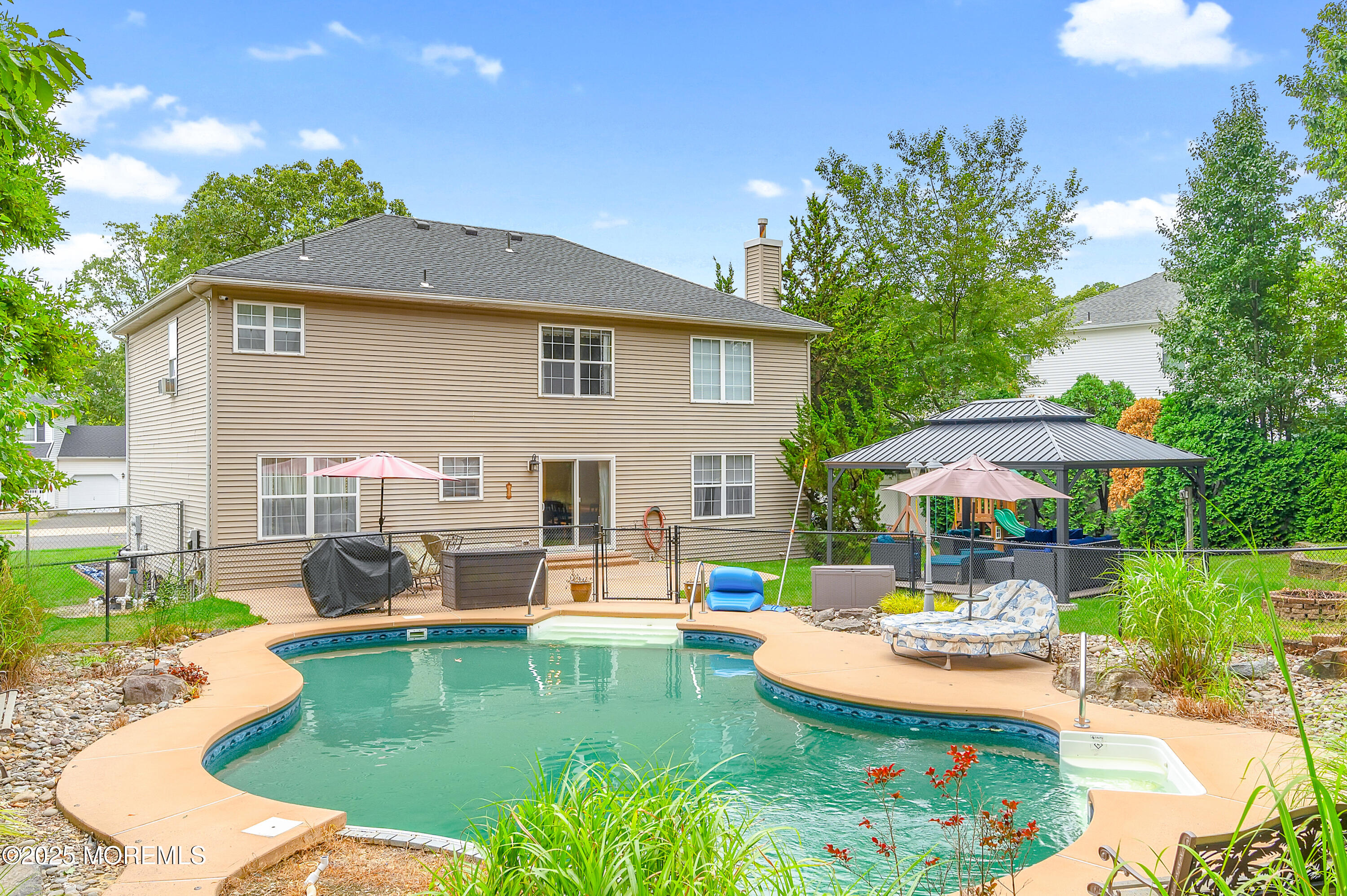 76 Diamond Lane Howell, NJ 07731 - Photo 30 of 36 a view of a patio with couches table and chairs under an umbrella