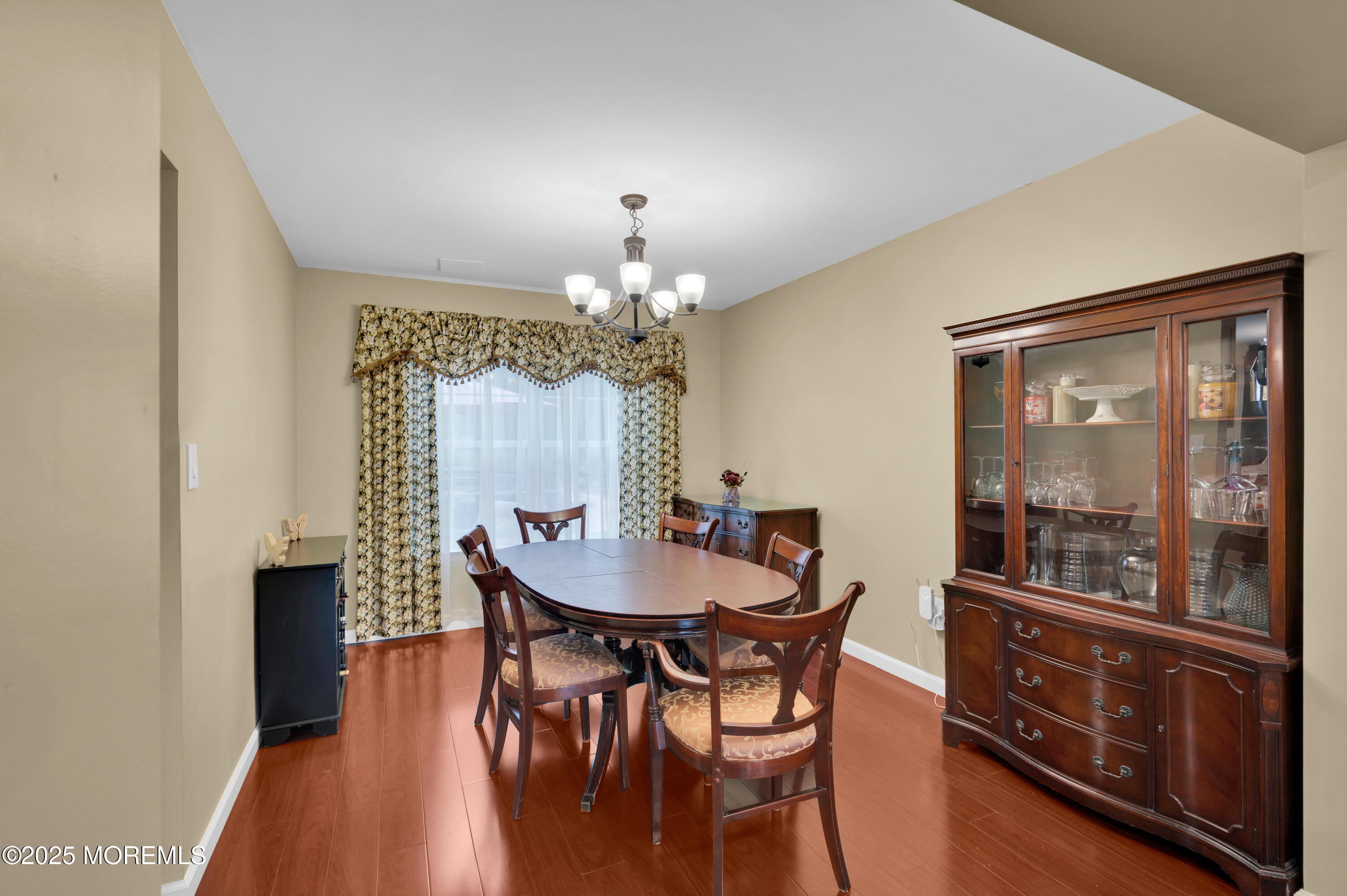 76 Diamond Lane Howell, NJ 07731 - Photo 7 of 36 a dining room with furniture a chandelier and wooden floor