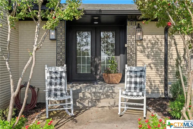 a living room with furniture ceiling fan and a rug