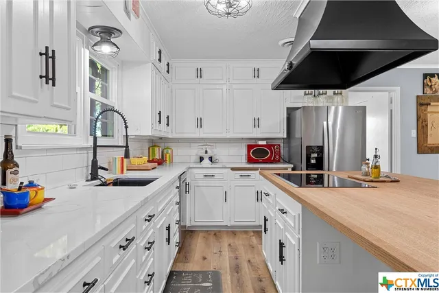 a view of a livingroom with furniture and a flat screen tv