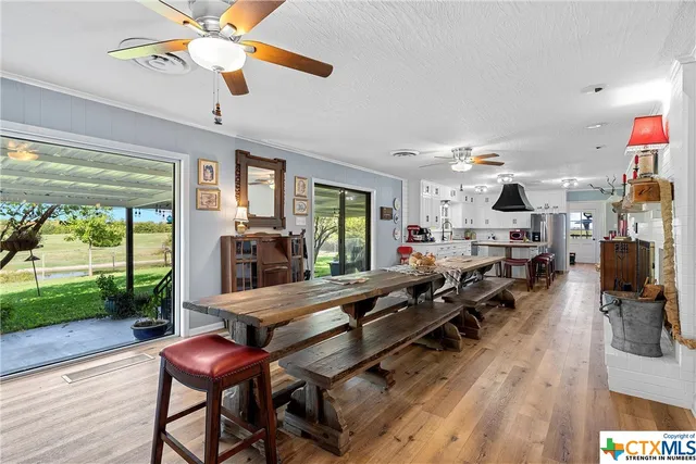 a living room with furniture a window and a flat screen tv