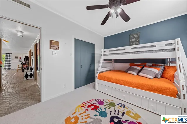 a view of a house with a yard and potted plants