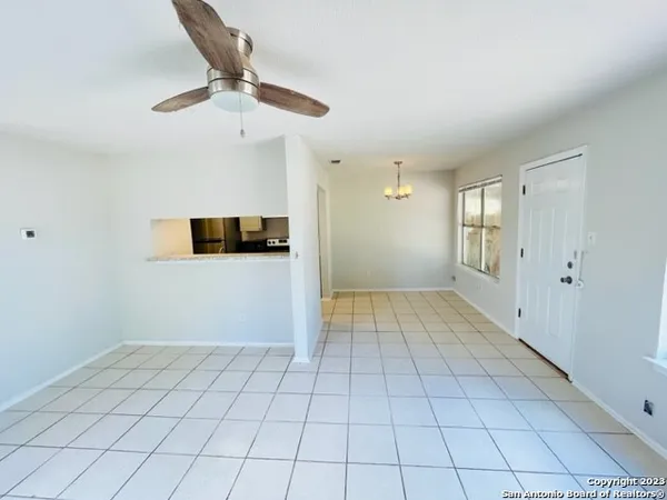 a view of a livingroom with an empty space and a ceiling fan