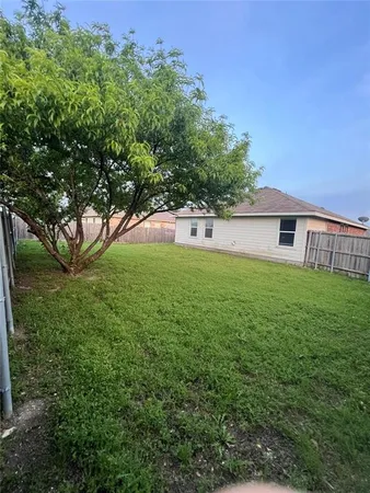 a view of house with a yard