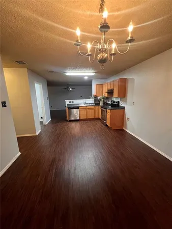 a view of a room with furniture and wooden floor