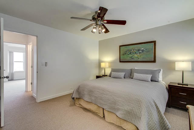1007 East 61st Street Chicago, IL 60637 - Photo 11 of 20 a bedroom with a bed and a chandelier