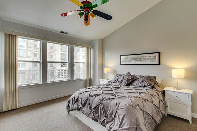 1007 East 61st Street Chicago, IL 60637 - Photo 13 of 20 a bedroom with a bed and a chandelier