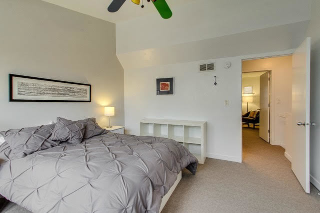 1007 East 61st Street Chicago, IL 60637 - Photo 14 of 20 a bedroom with a bed and a chandelier