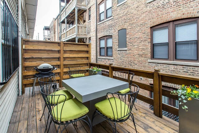 1007 East 61st Street Chicago, IL 60637 - Photo 8 of 20 a backyard of a house with barbeque oven table and chairs
