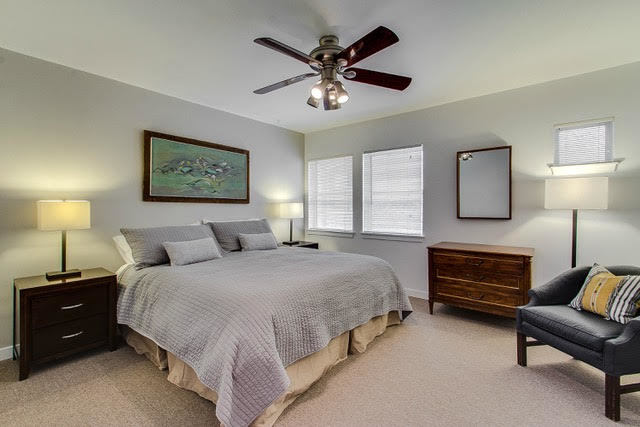1007 East 61st Street Chicago, IL 60637 - Photo 10 of 20 a spacious bedroom with a bed and a chandelier