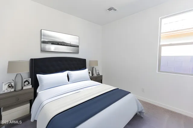 a bedroom with a bed and window