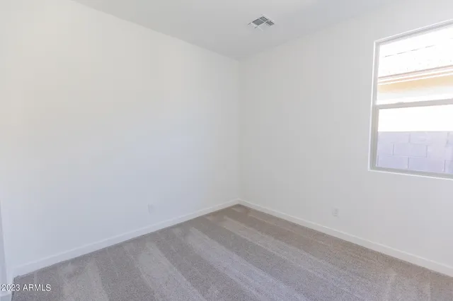 a view of a small space with wooden floor and a window