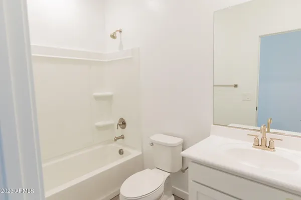 a white toilet sitting next to a bath tub
