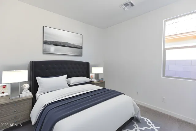 a bedroom with a bed and window