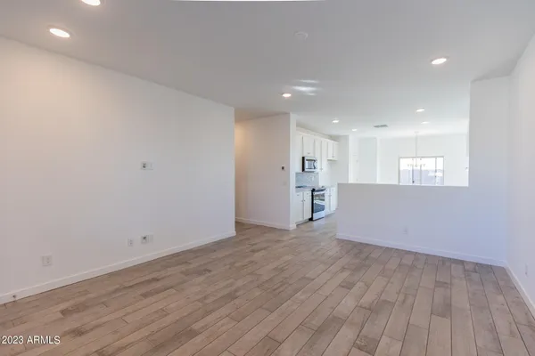 a view of empty room with wooden floor