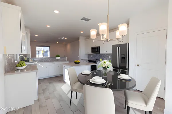 a kitchen that has a table and chairs in it