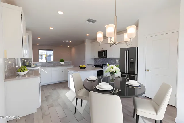 a kitchen that has a table and chairs in it