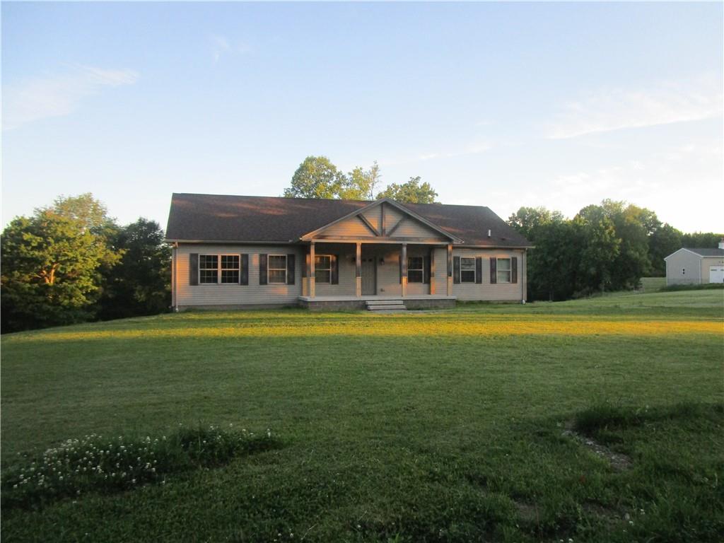 a front view of house with outdoor space and swimming pool
