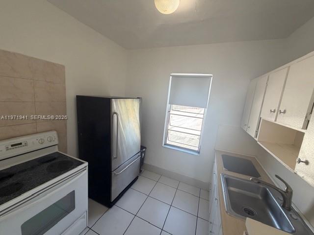 2368 Northwest 3rd Street, Unit 4 Miami, FL 33125 - Photo 6 of 20 a kitchen with a refrigerator stove and sink