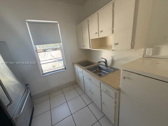 2368 Northwest 3rd Street, Unit 4 Miami, FL 33125 - Photo 7 of 20 a kitchen with cabinets appliances and a sink