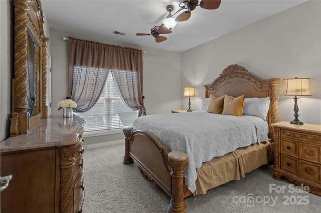 a bedroom with a bed a mirror and dresser