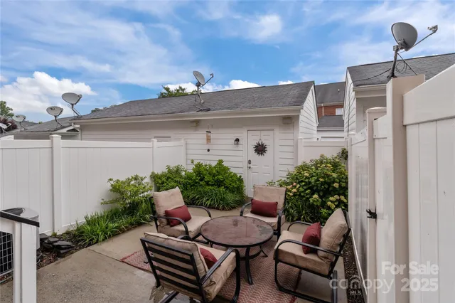 a view of a backyard with furniture and a potted plants