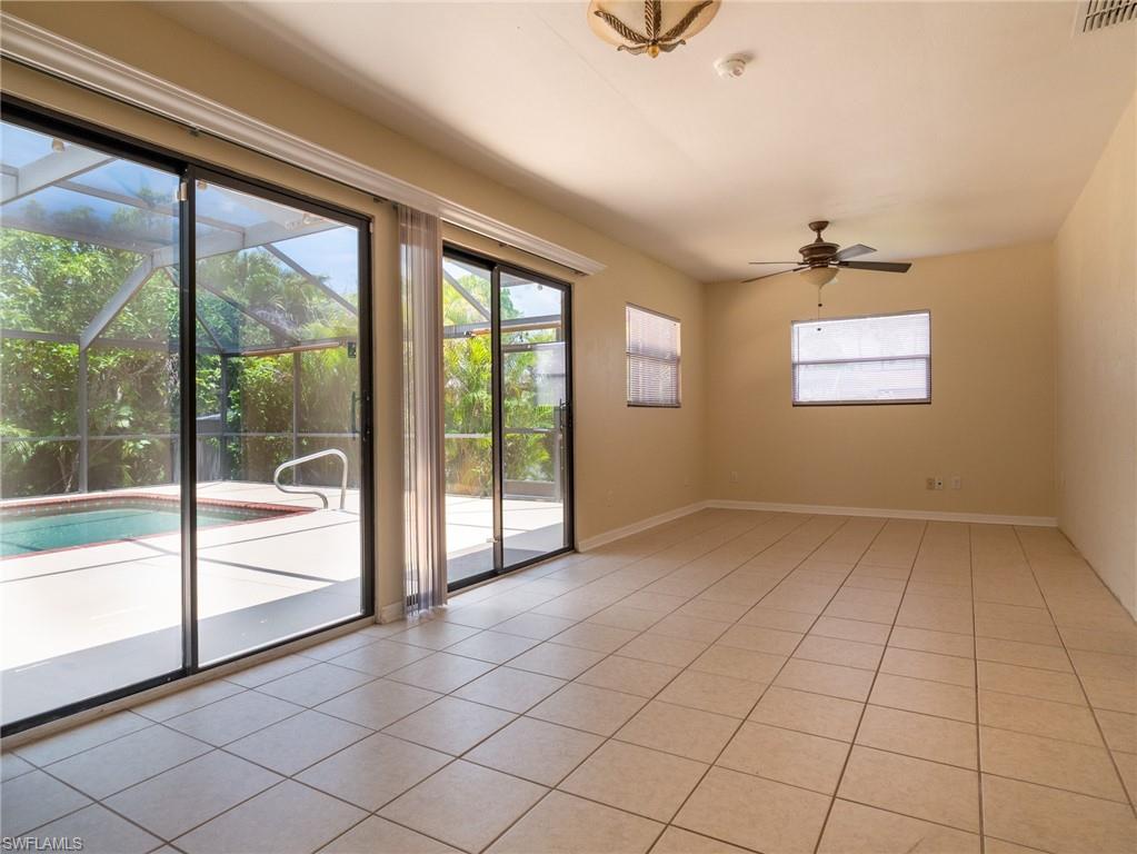 18414 Tulip Road Fort Myers, FL 33967 - Photo 14 of 37 Spacious interior featuring tile flooring, multiple windows, and a ceiling fan
